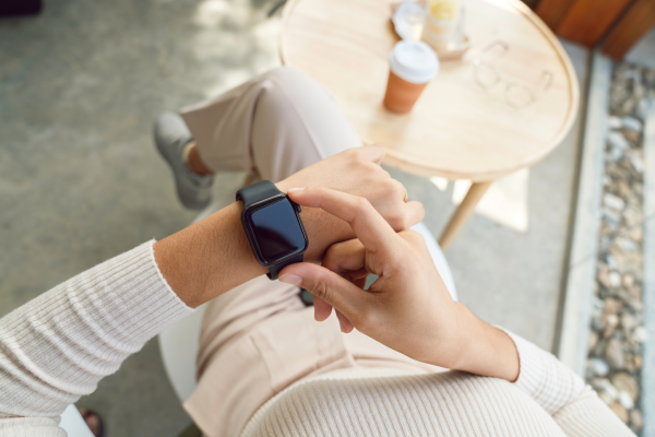 person checking their wearable device while out