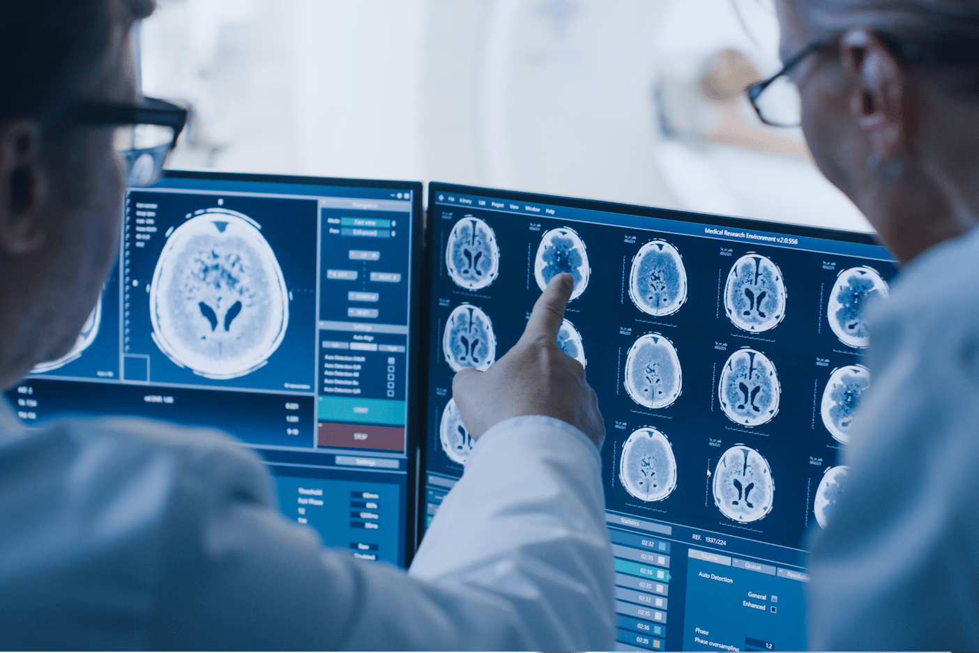 Photo of two medical professionals viewing brain images on a computer