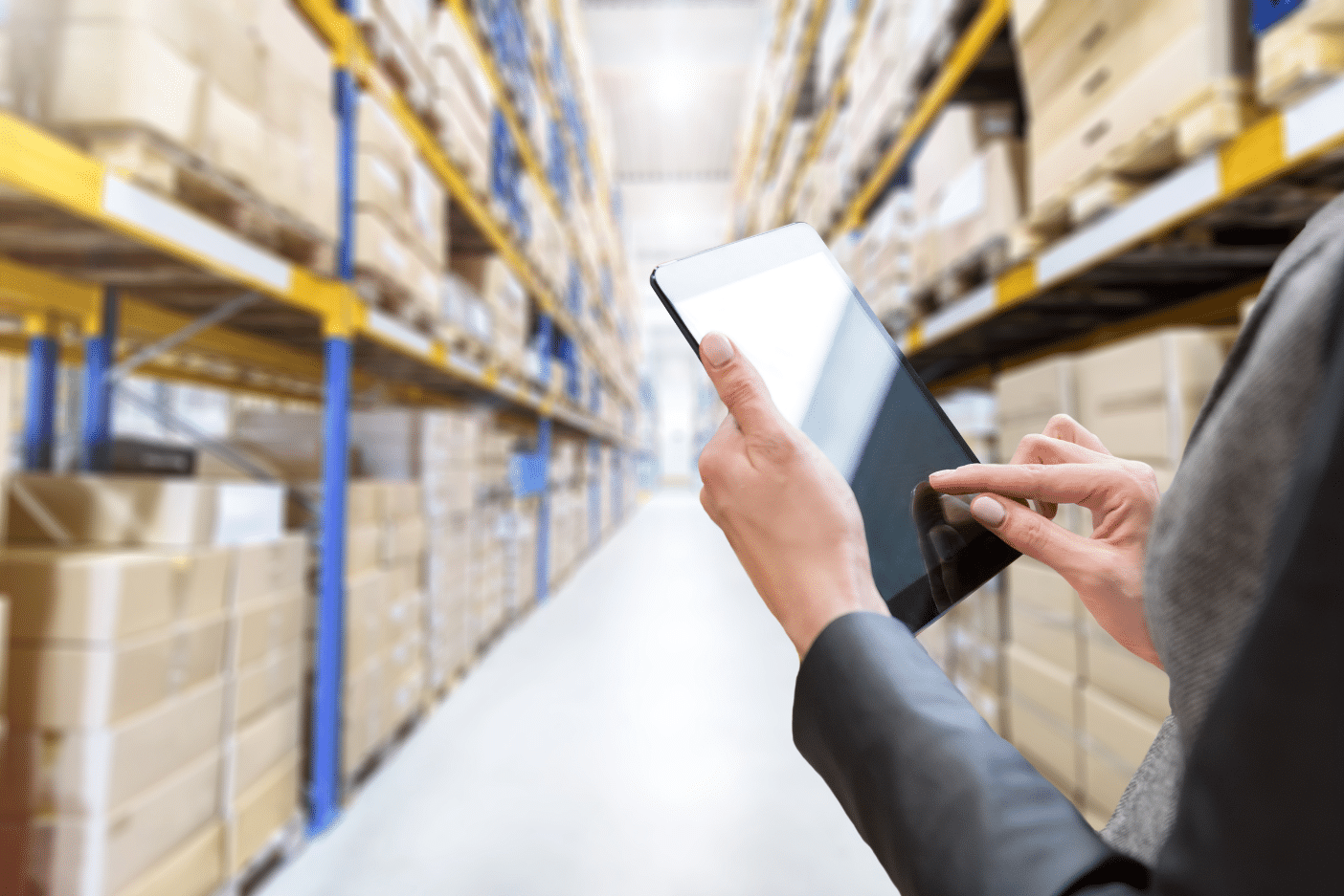 Person tracking inventory on a tablet in a warehouse for a clinical trial
