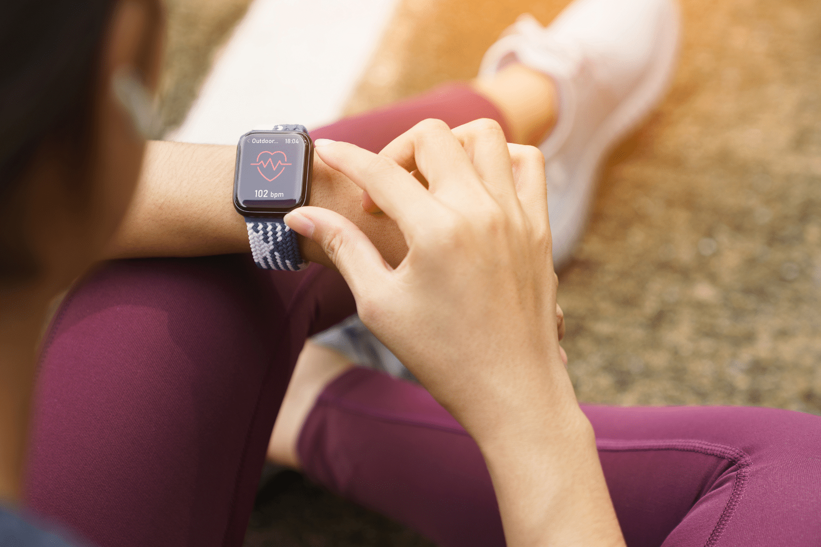 person checking their wearable device while out