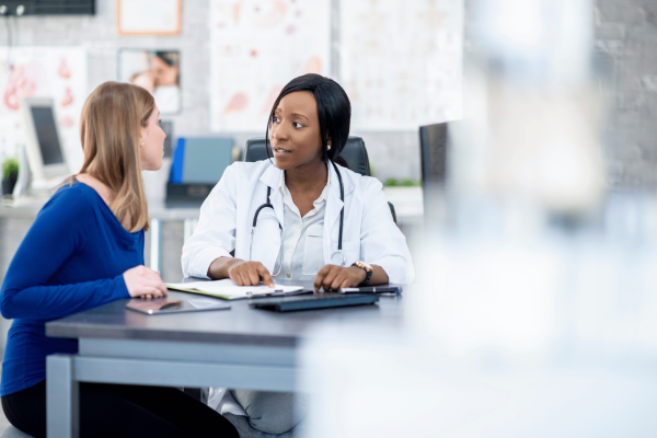 clinician and patient sit together reviewing info for clinical trial