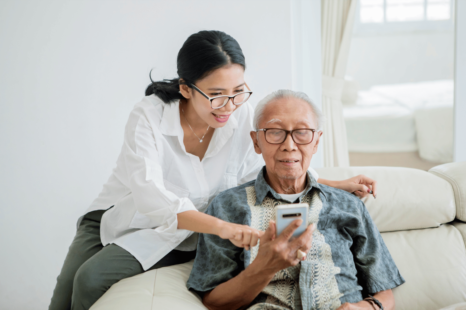 caregiver and patient at home using smartphone for clinical trial