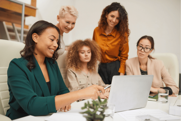 Team of research professionals looking at a laptop screen together
