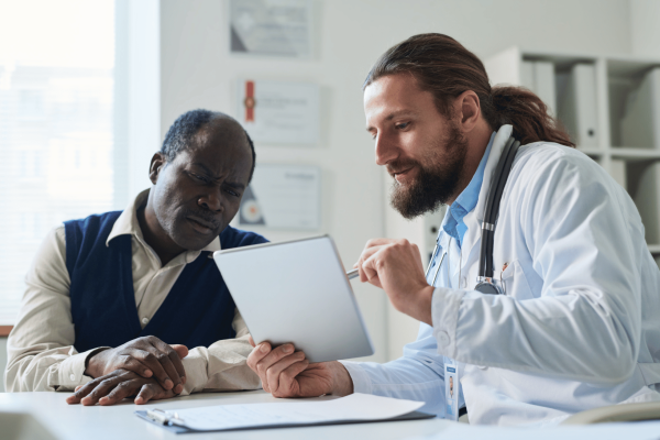 Site staff reviewing information with study participant on a smart tablet
