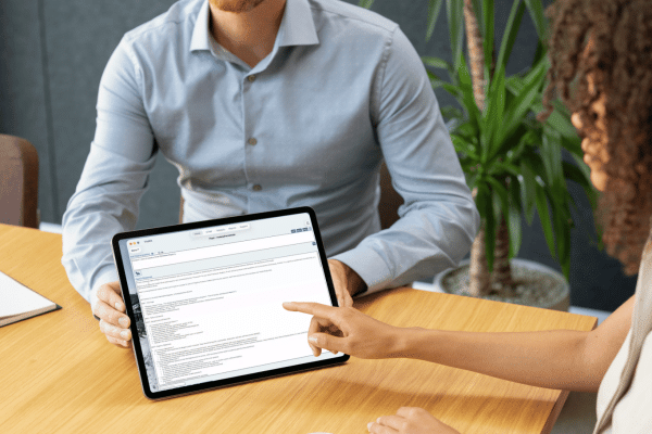 two research professionals view a tablet screen showing a study protocol generated by AI